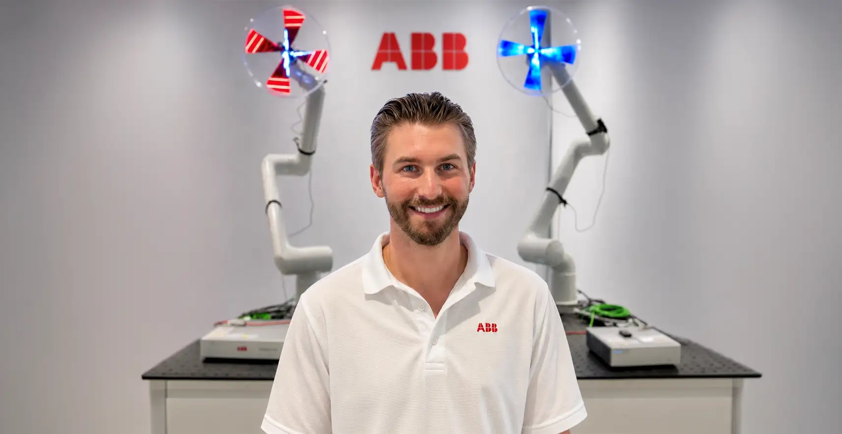 James Barrett standing in front of robotics machine