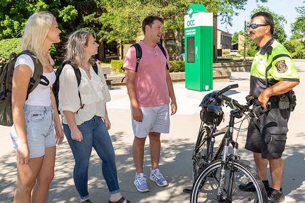 Officer talks with students