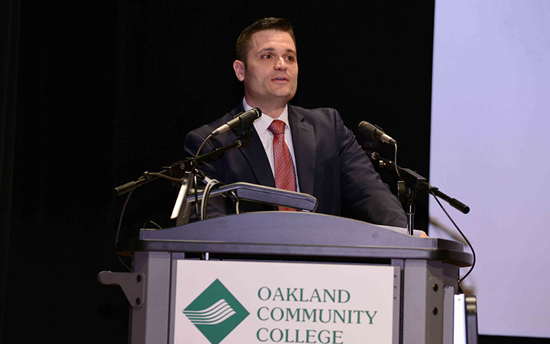 David Ceci standing at a podium. 