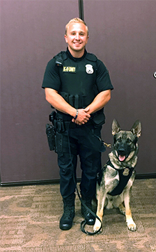 Officer posing with his k9 partner.