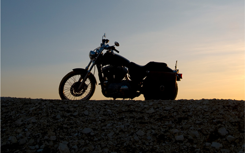 A motorcycle with a landscape background. 