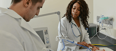 Two respiratory therapy students in a classroom setting. 