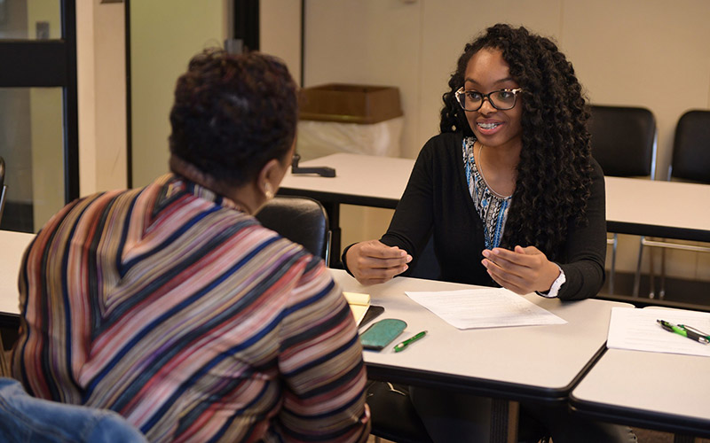 Alum, G'Angela Roquemore speaking with OCC staff